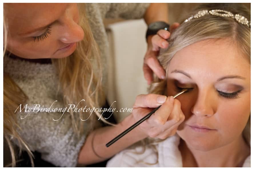 Bride receiving makeup - photo courtesy of My Birdsong Photography